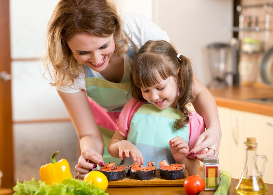 Mother-And-Daughter-Cooking-Indoors